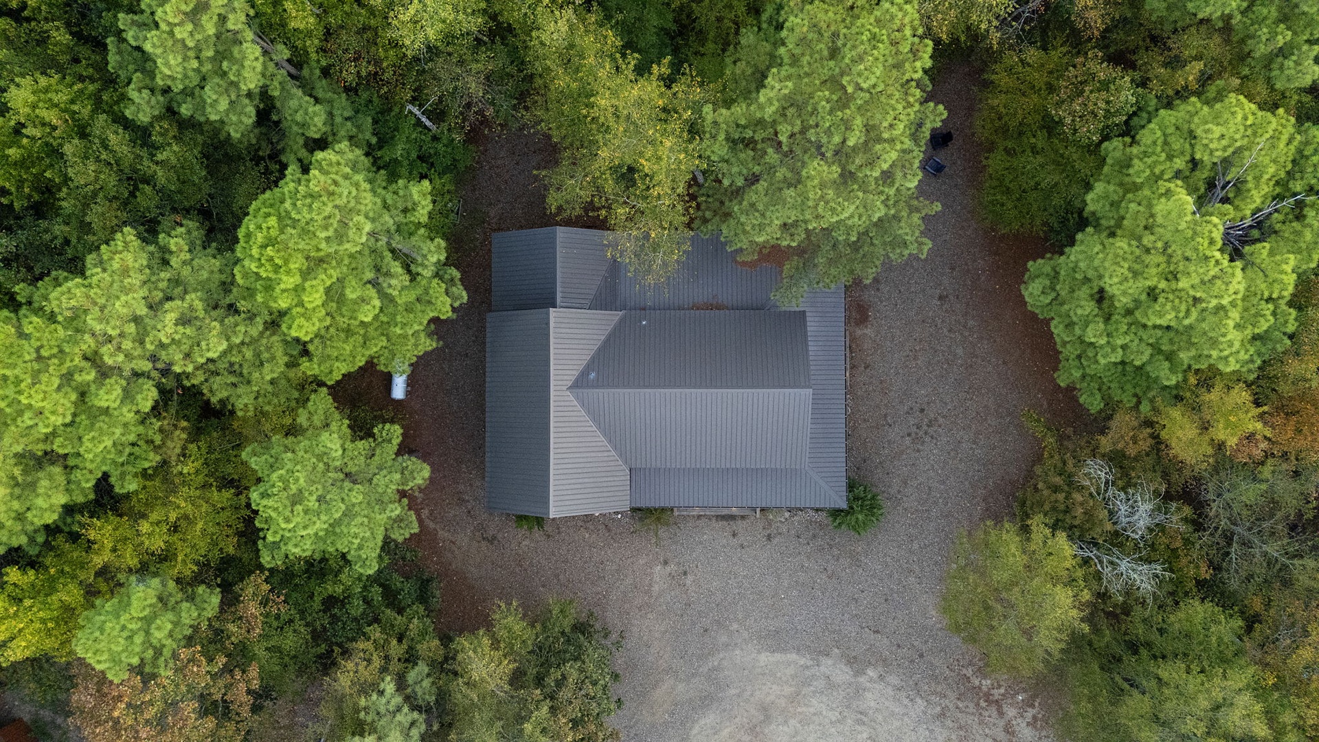 A secluded modern retreat nestled in lush forest surroundings, offering complete privacy and a peaceful woodland setting just moments from your arrival.