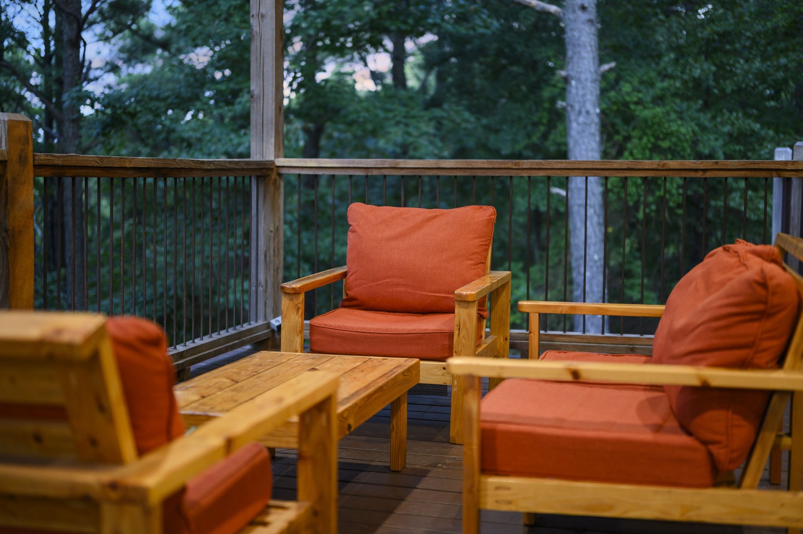 Settle into your private deck surrounded by towering trees, where the forest wraps around you in quiet tranquility and every moment feels like a peaceful escape.