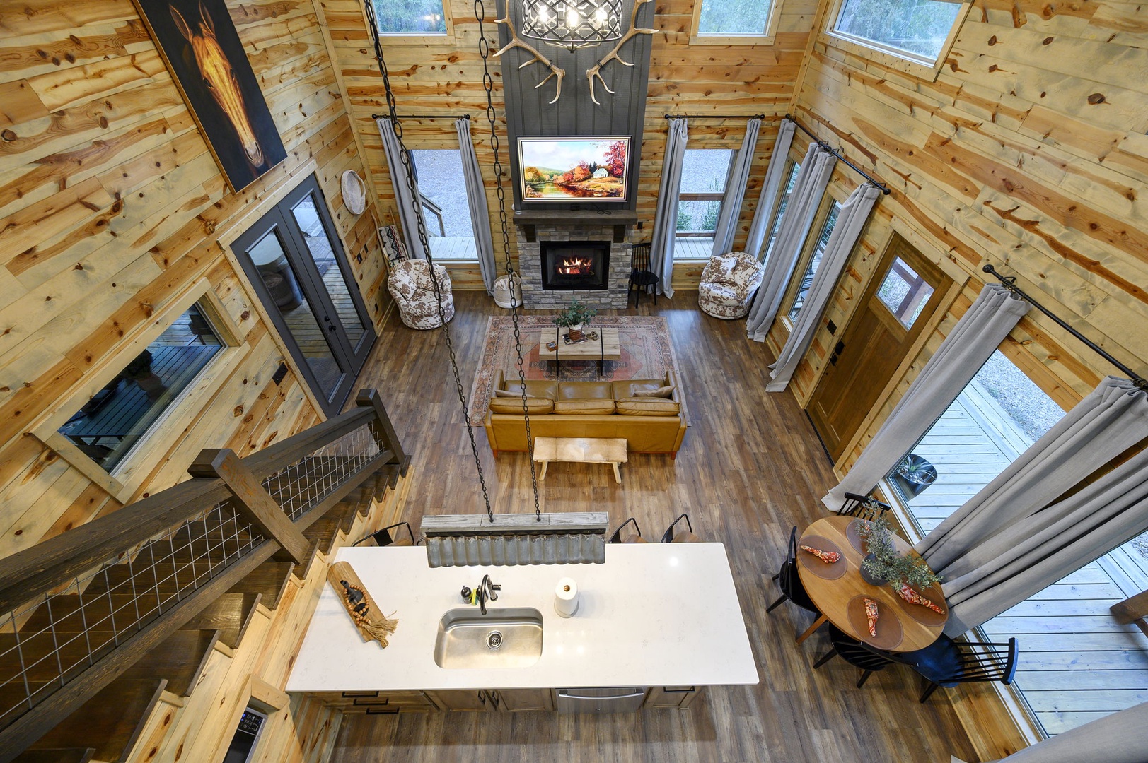 Soaring ceilings, warm wood tones, and abundant natural light create your cozy mountain retreat. The fireplace, open layout, and rustic charm invite you to relax and unwind in style.