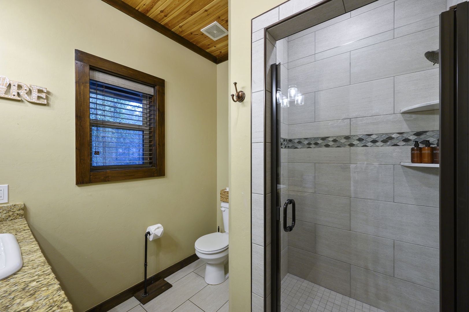 Refresh in your private bathroom with a spacious walk-in shower featuring modern tile work and thoughtful details that make every moment feel special.