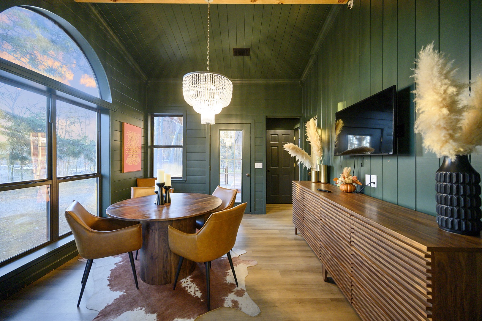 Gather around this stunning oval dining table where warm wood tones and elegant design create the perfect setting for memorable meals together.