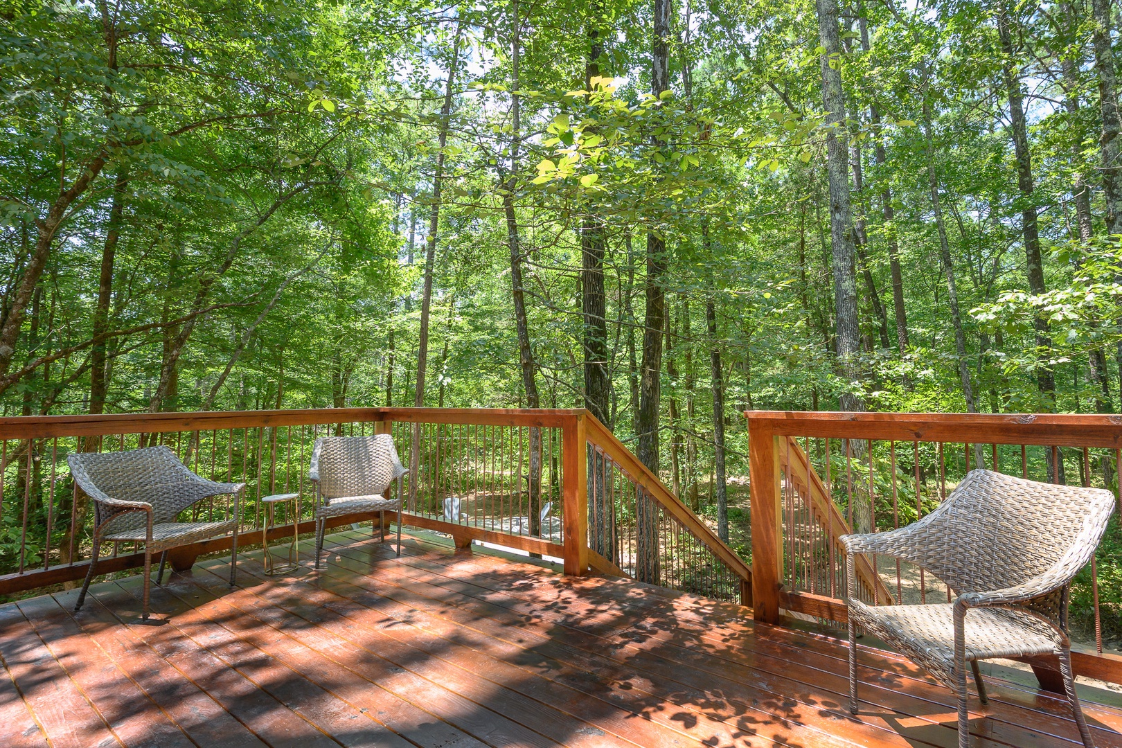 The property is nestled within a lush wooded area, offering a peaceful natural setting surrounded by mature trees.