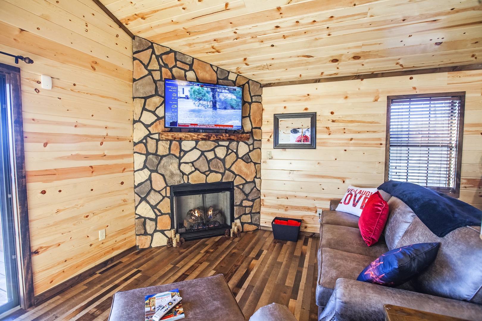 Cozy up in your rustic living room with stone fireplace, flat-screen TV, and plush seating for perfect mountain retreat evenings.
