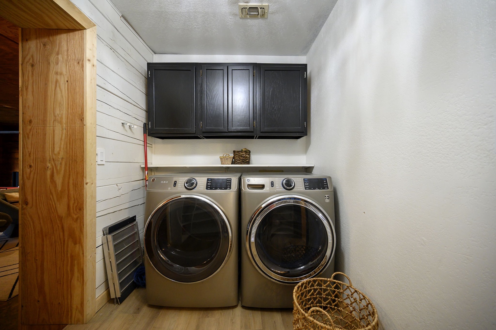 Your laundry worries disappear in this convenient space with full-size washer and dryer, plus ample storage for all your needs.