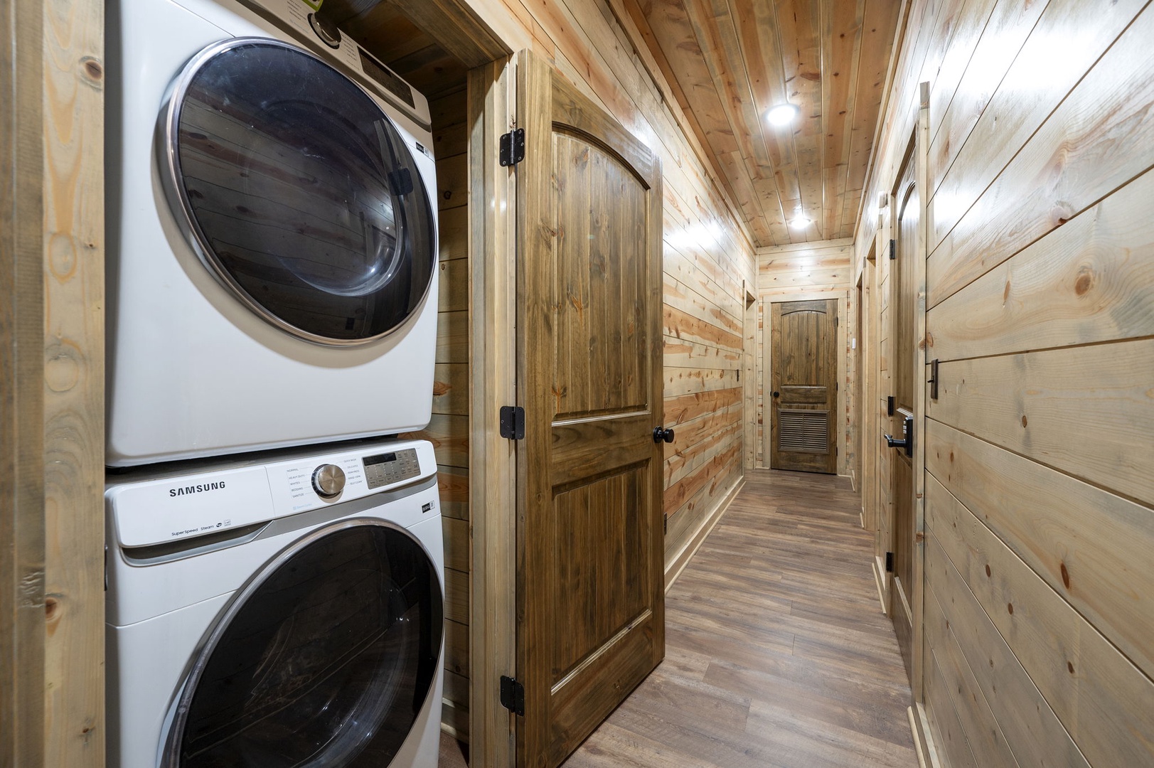 Your laundry needs are covered with convenient in-unit washer and dryer, tucked away in this warm wood-paneled hallway.