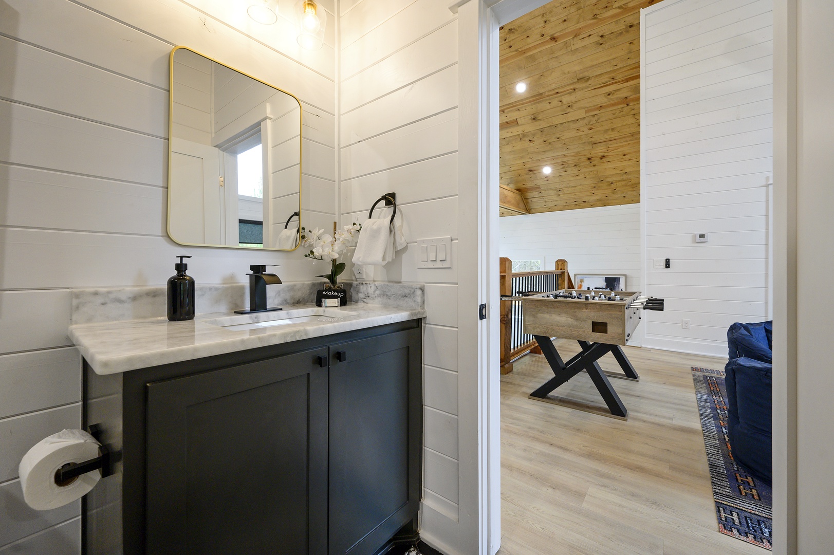 Freshen up in your stylish bathroom with marble countertops and modern amenities, perfectly positioned near your cozy living space.