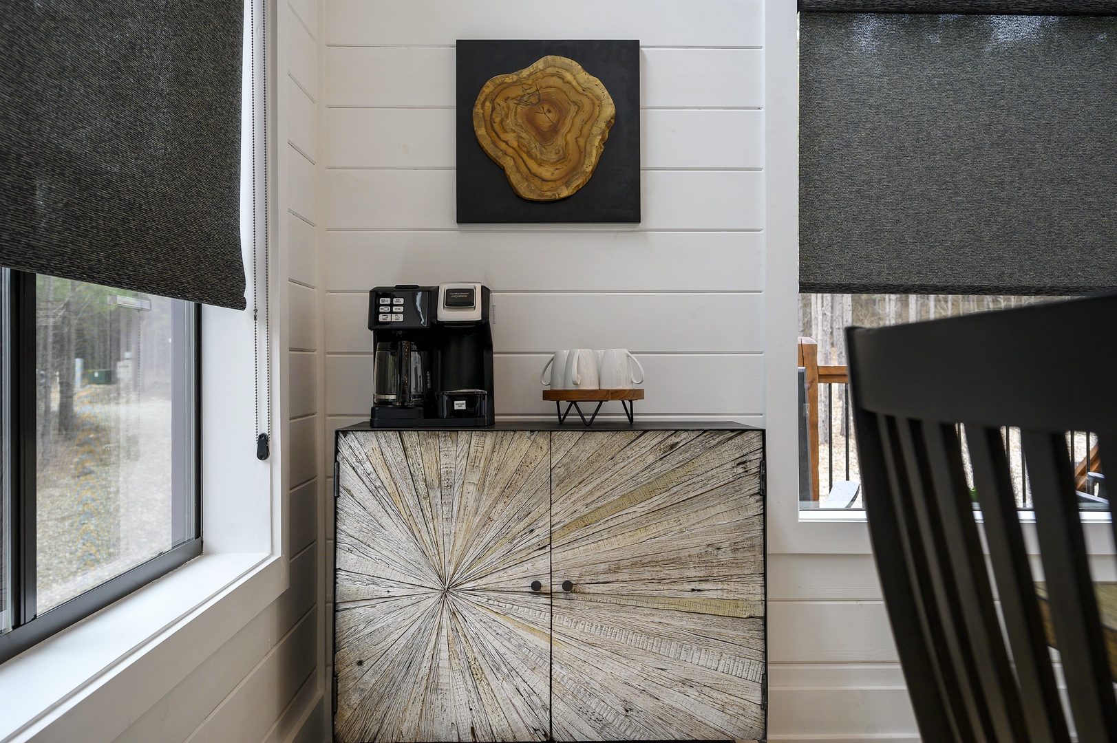 Your morning coffee station awaits with premium brewing equipment and stylish storage in this thoughtfully designed nook.