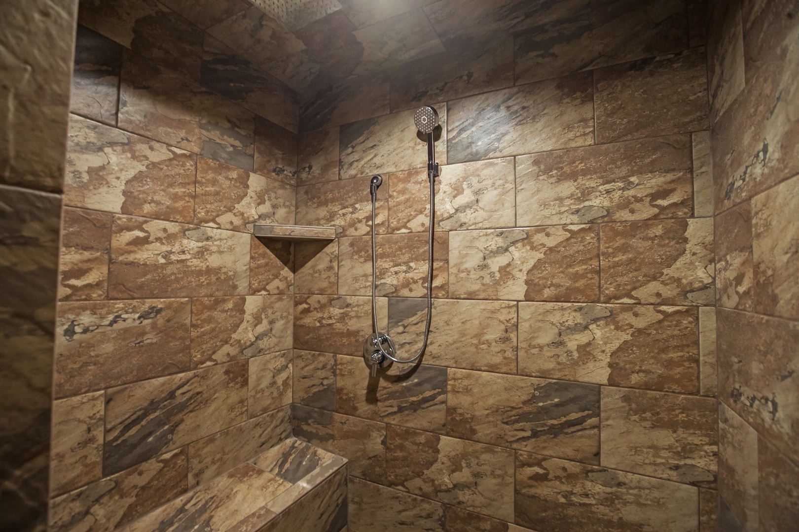 Indulge in your private marble sanctuary, where rich stone surrounds you and rainfall showers create a spa-like retreat.