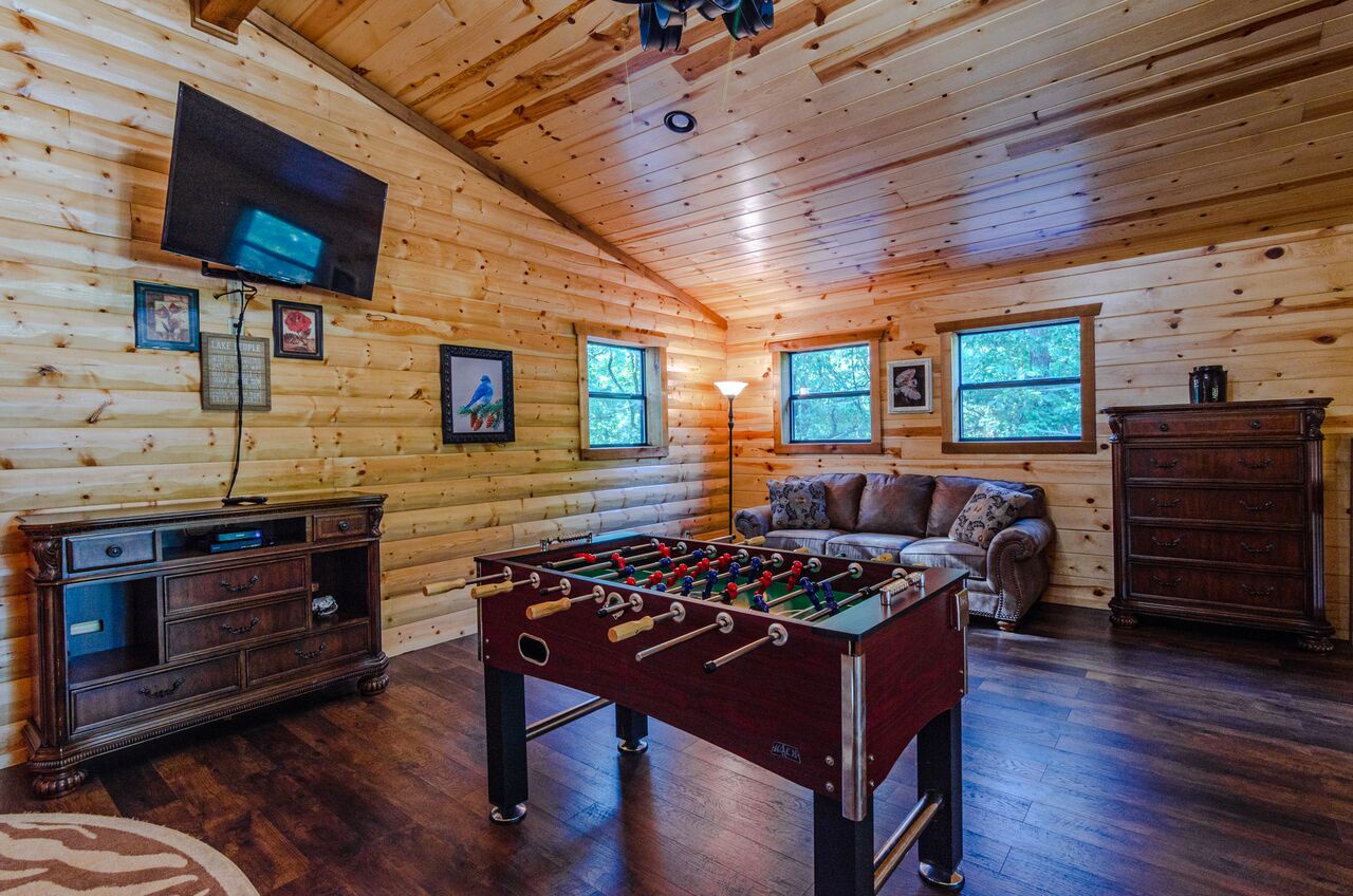 Challenge friends to foosball beneath soaring pine ceilings, sink into the plush sofa for movie nights, or simply unwind in your own game room retreat.