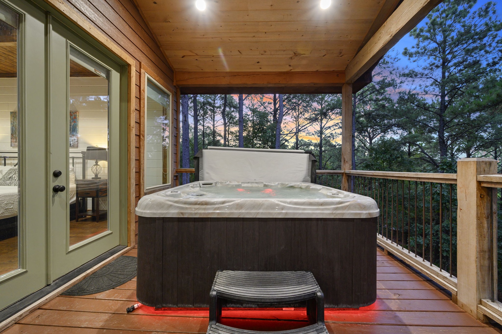 Step onto your private covered deck and slip into the bubbling hot tub as twilight paints the forest skyline in soft pastels—pure mountain relaxation awaits.