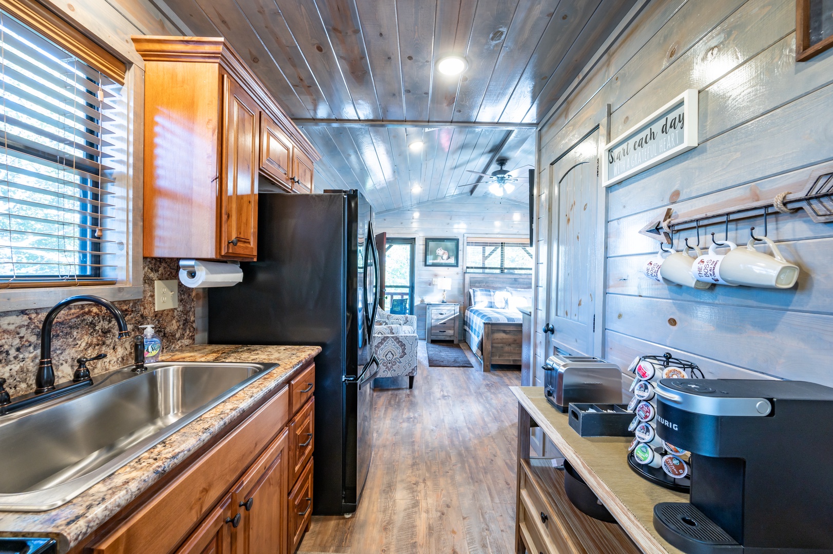 Your fully equipped kitchen features granite counters, stainless appliances, and charming wood details - perfect for preparing meals while enjoying the cozy cabin atmosphere.