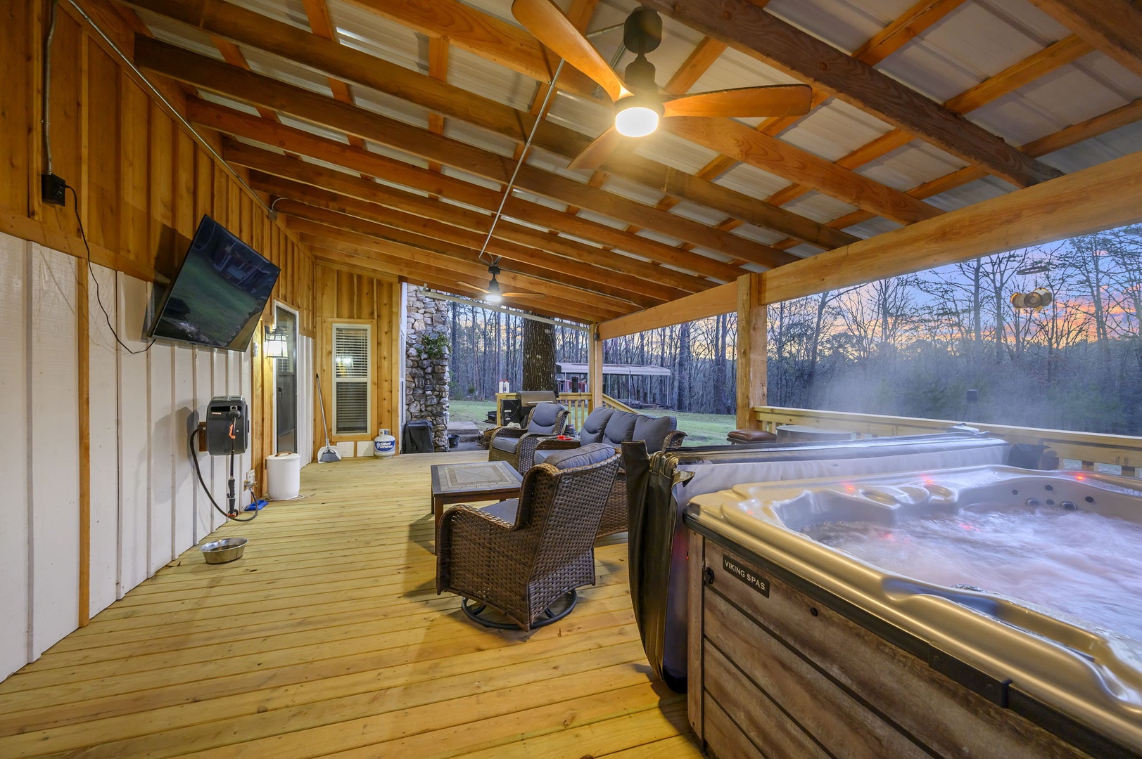 Sink into your private hot tub while watching your favorite shows on the outdoor TV in this cozy covered deck retreat.