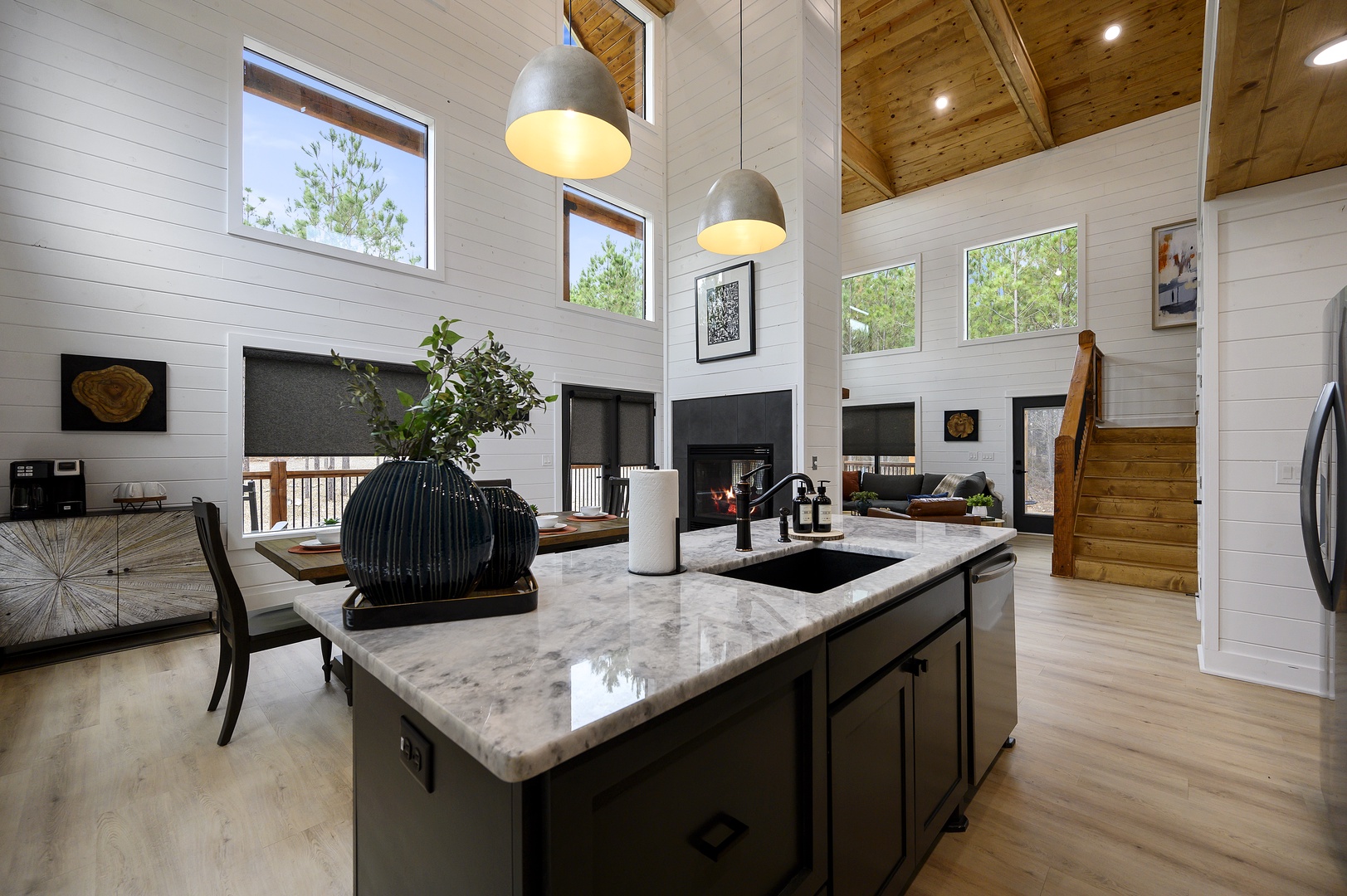 Your gourmet kitchen features marble countertops, modern appliances, and soaring ceilings that create an airy, luxurious cooking space.