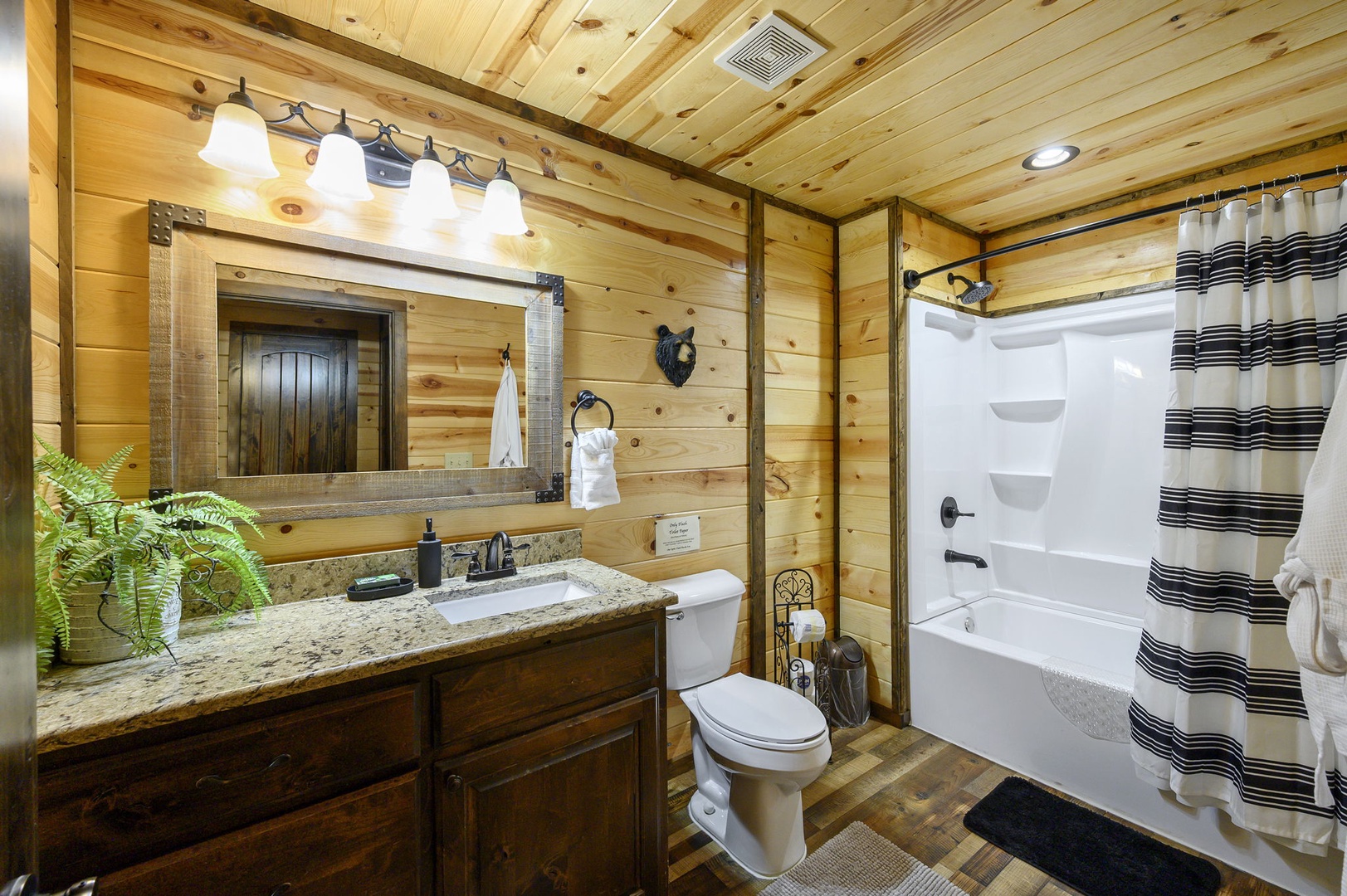 Refresh in your private bathroom featuring warm wood finishes, granite counters, and a tub-shower combo—all the comforts you need to unwind after a day exploring.