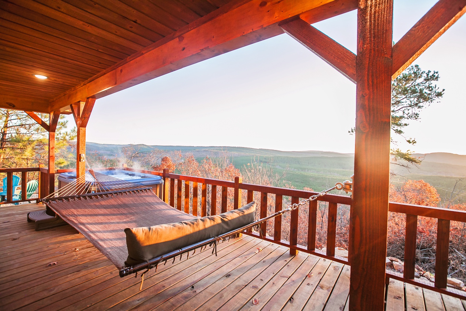 Relax in your private hammock on this stunning wooden deck, where autumn colors meet mountain vistas in perfect harmony.
