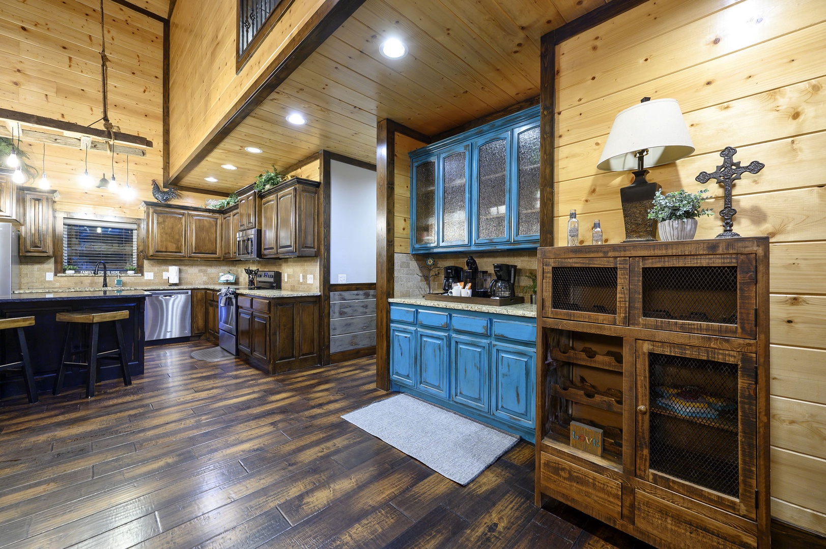 Step into your spacious chef's kitchen with stunning wood-beam ceilings and charming rustic cabinetry—plenty of room to whip up meals or gather with loved ones for a cozy stay.