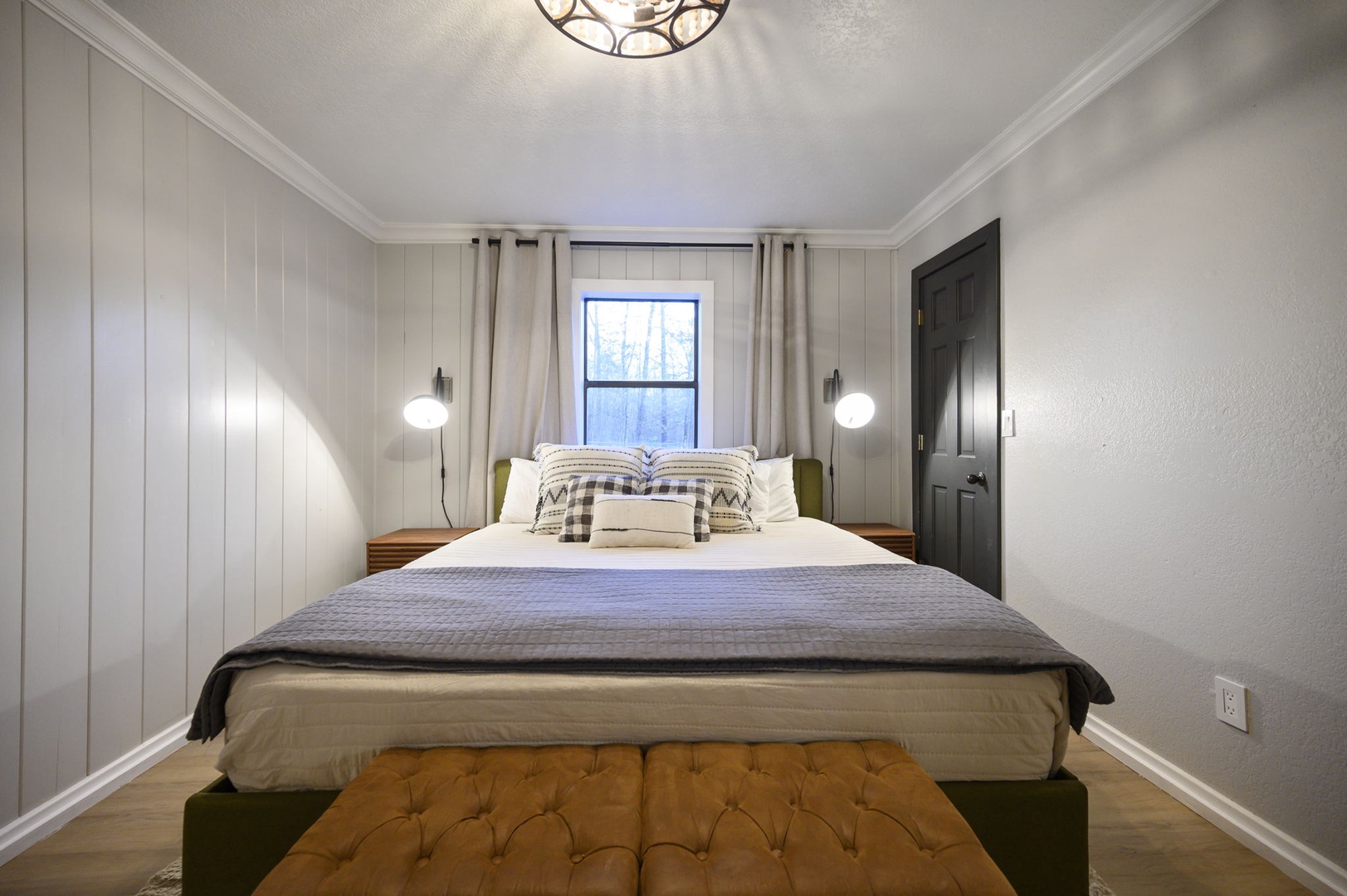 Unwind in your stylish bedroom featuring a plush bed, modern lighting, and thoughtful design touches that create the perfect retreat.