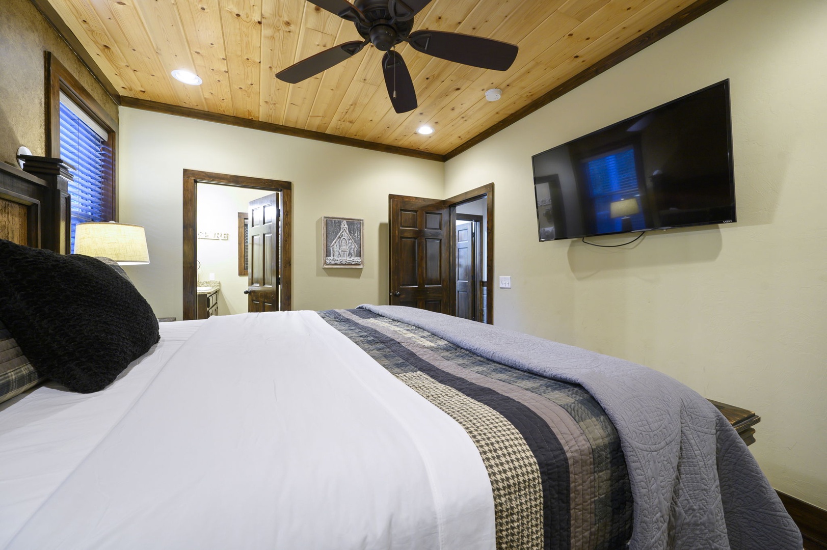 Unwind in your cozy bedroom, where warm wood ceilings and soft linens create a peaceful retreat. A ceiling fan keeps you comfortable, and you'll enjoy an ensuite for added privacy and convenience.