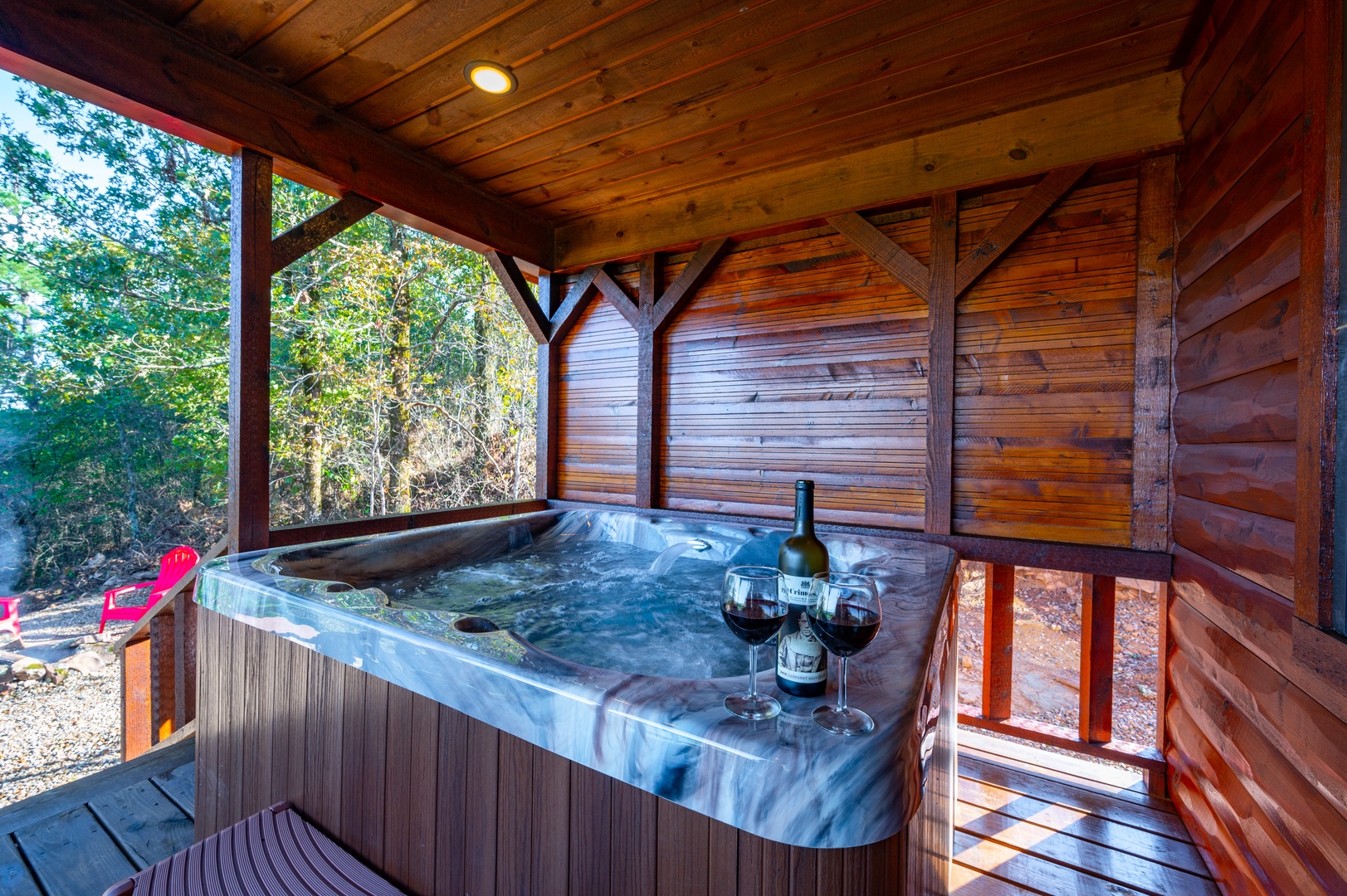 Soak in your private hot tub surrounded by natural beauty, with wine ready to enhance your perfect relaxation retreat.