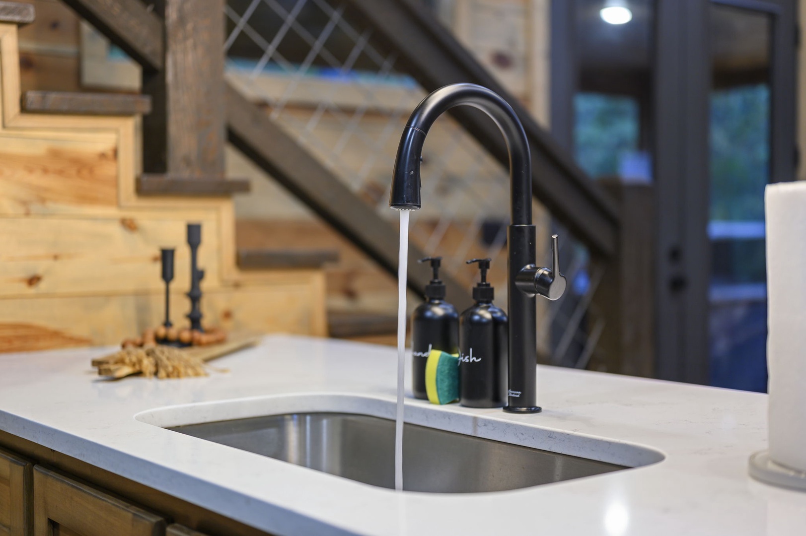 Sleek countertops and a modern sink invite you to prep meals with ease in this well-appointed kitchen space.