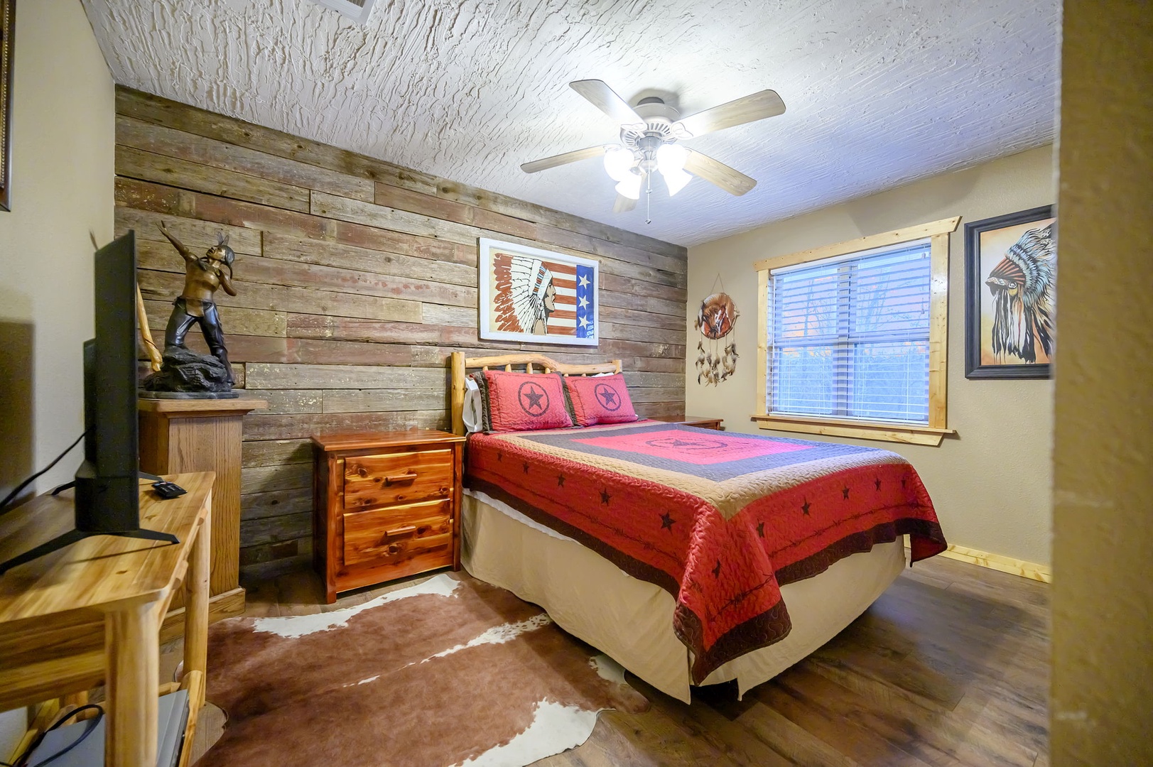Your rustic retreat features Western-themed decor with reclaimed wood walls and Native American artwork, creating an authentic frontier atmosphere.