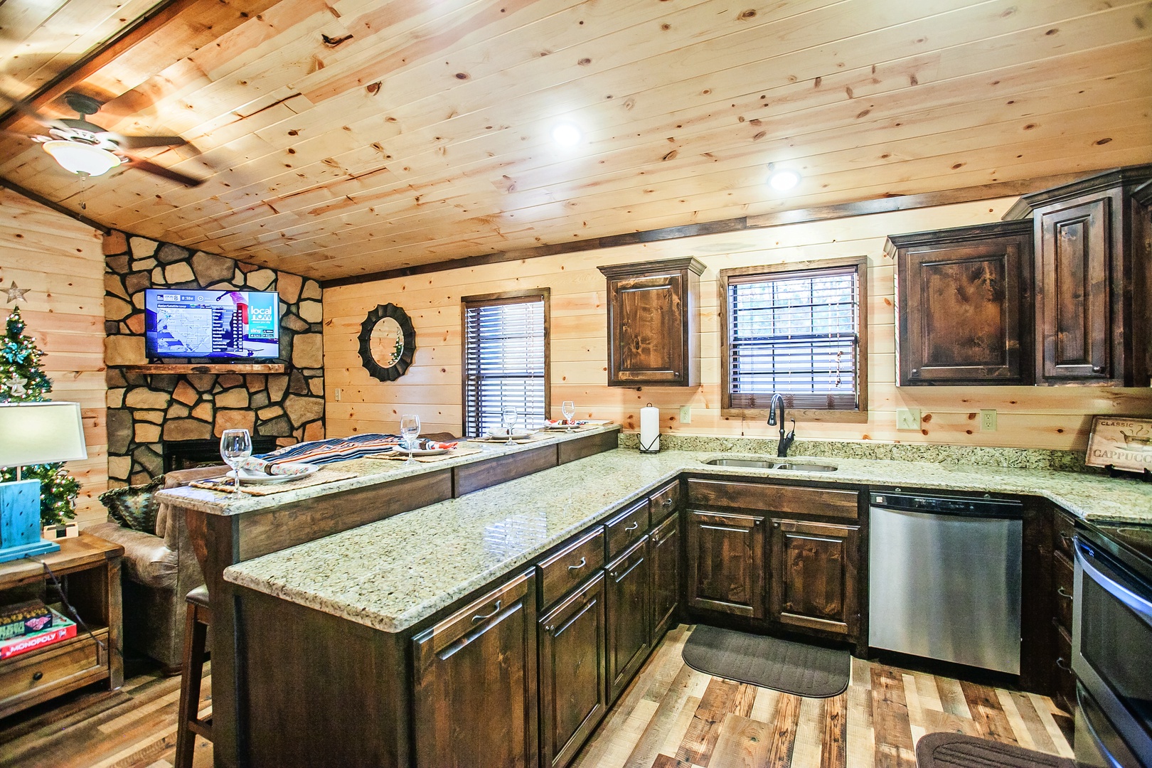 Your rustic mountain kitchen features granite countertops, stone fireplace, and modern appliances for cozy cooking adventures.