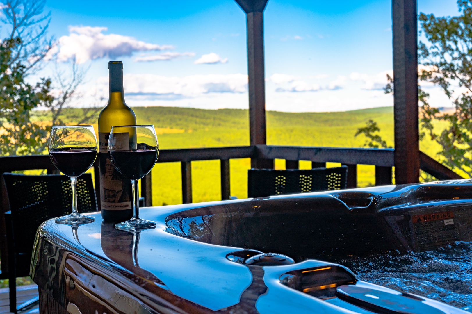 Unwind in your private hot tub with wine as rolling countryside views stretch endlessly before you.