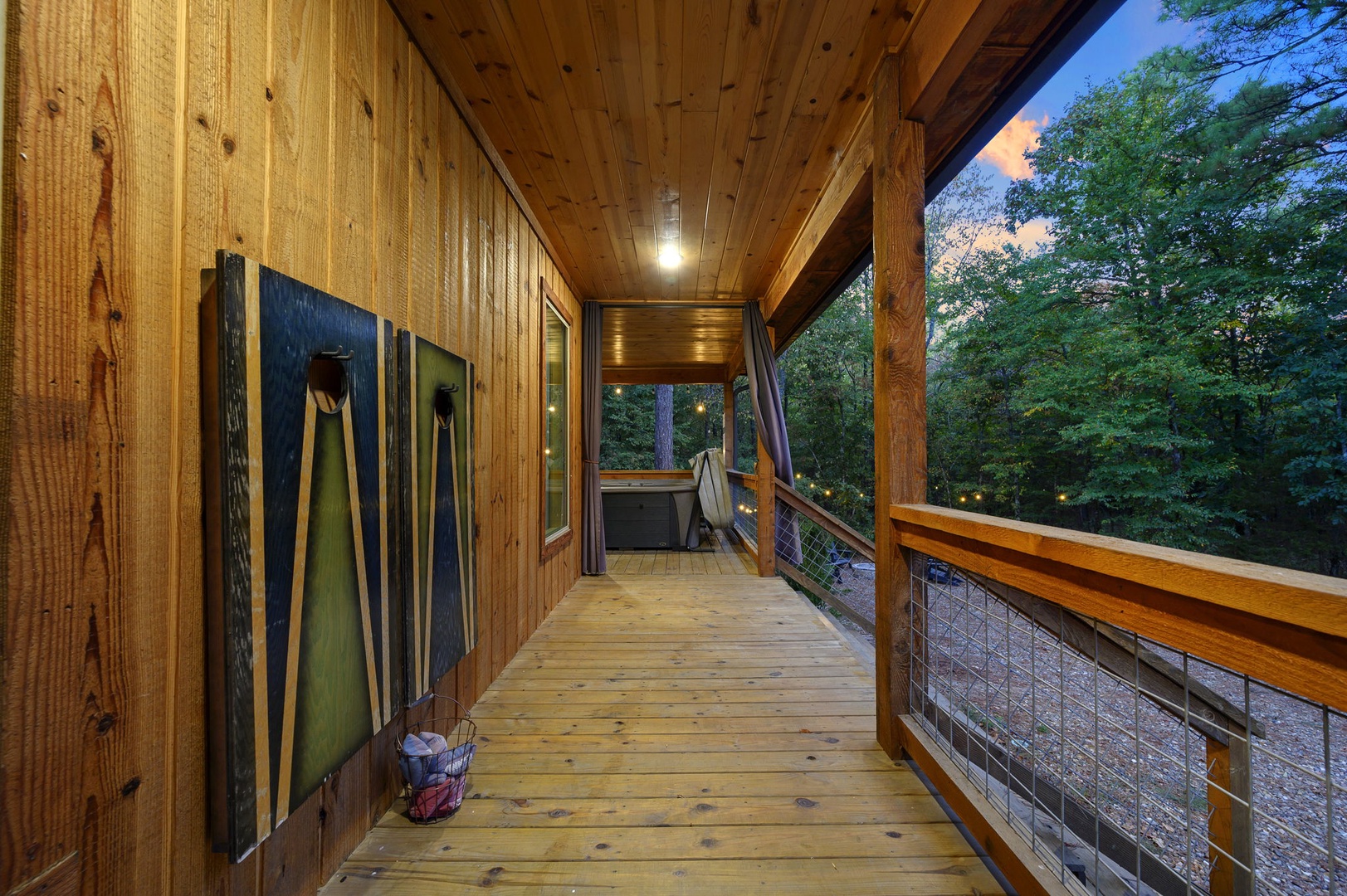 Step out onto your private covered deck and let the forest envelop you. Warm wood surrounds you while treetops sway beyond the railing—a perfect spot to unwind in the evening air.