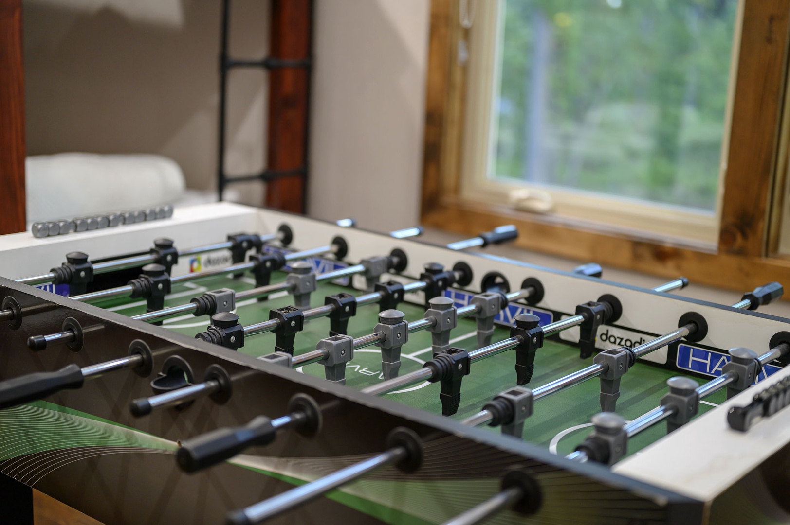 Challenge your travel companions to a spirited foosball match in your game room, where natural light streams through windows overlooking the peaceful surroundings. It's the perfect spot to unwind and enjoy some friendly competition during your stay.