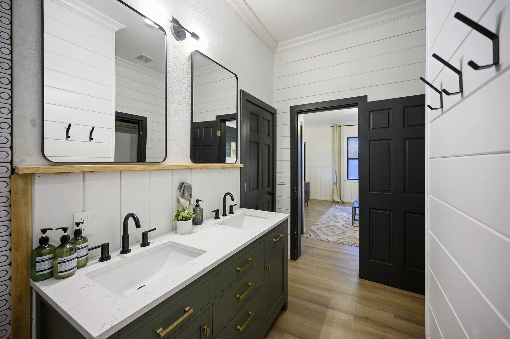 Refresh in your stylish farmhouse bathroom with dual vanities, modern fixtures, and elegant shiplap walls that create the perfect morning routine.