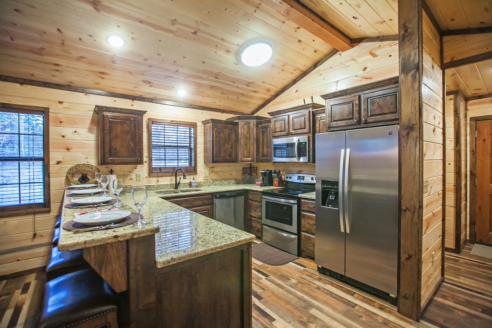 Your rustic mountain kitchen features granite counters, stainless steel appliances, and charming wood finishes for memorable meal preparations.