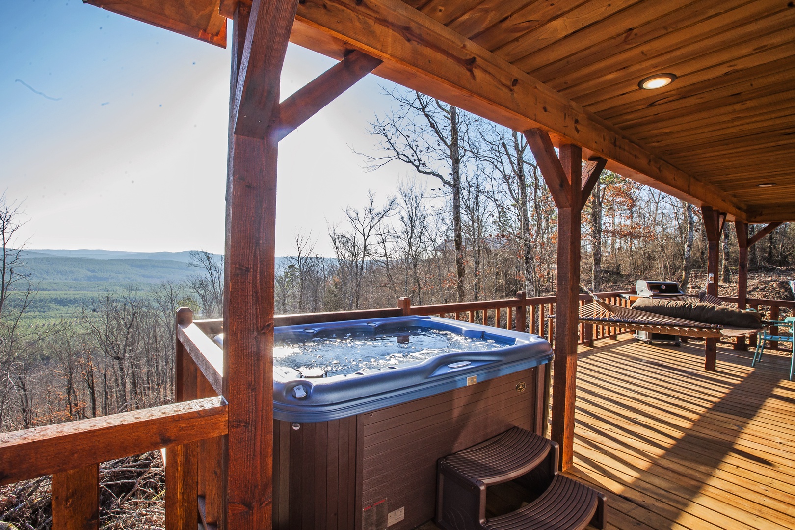 Soak in your private hot tub while gazing at breathtaking mountain vistas from this covered deck retreat.