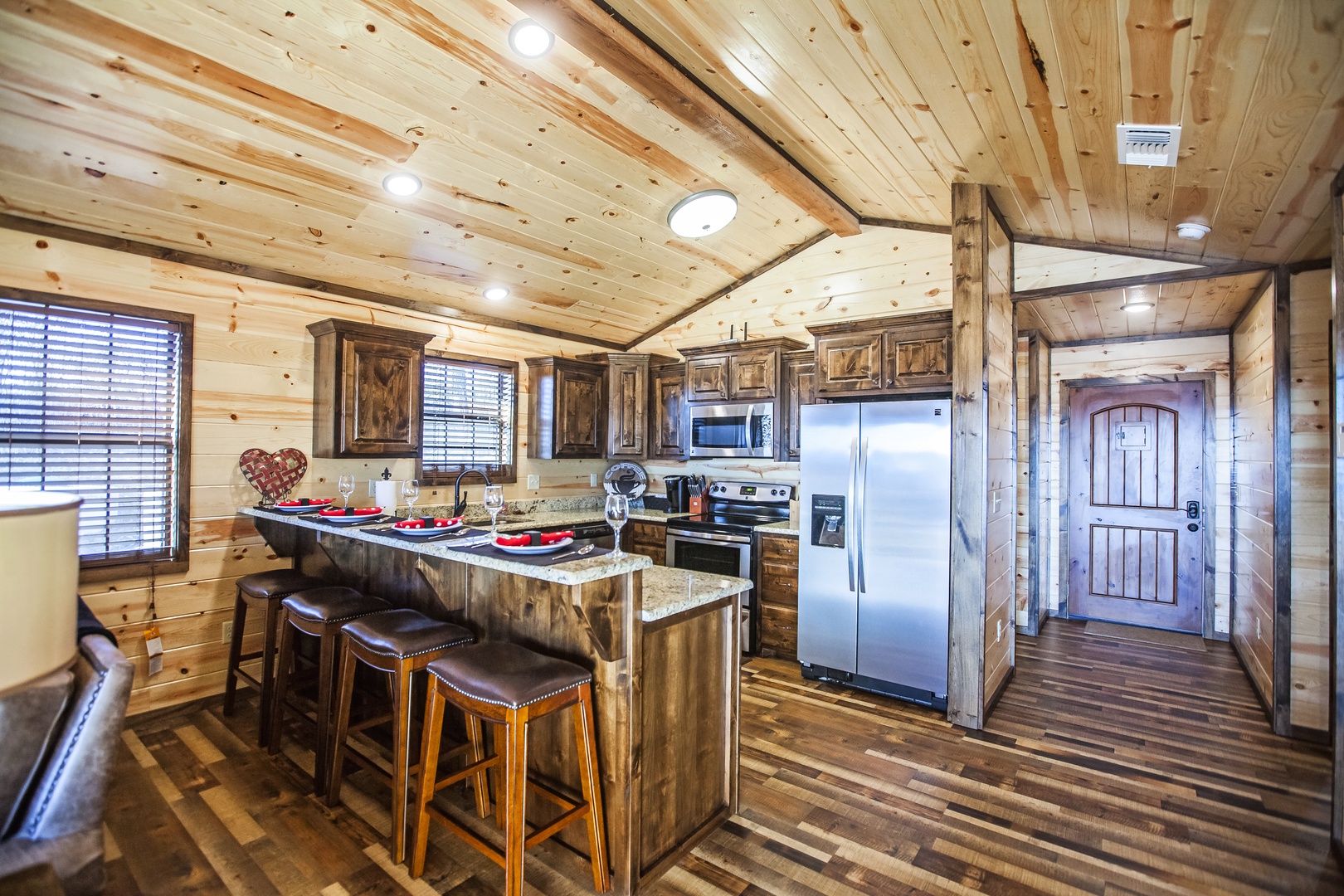 Create culinary memories in this rustic kitchen featuring rich wood finishes, granite countertops, and modern appliances perfectly blending comfort with functionality.