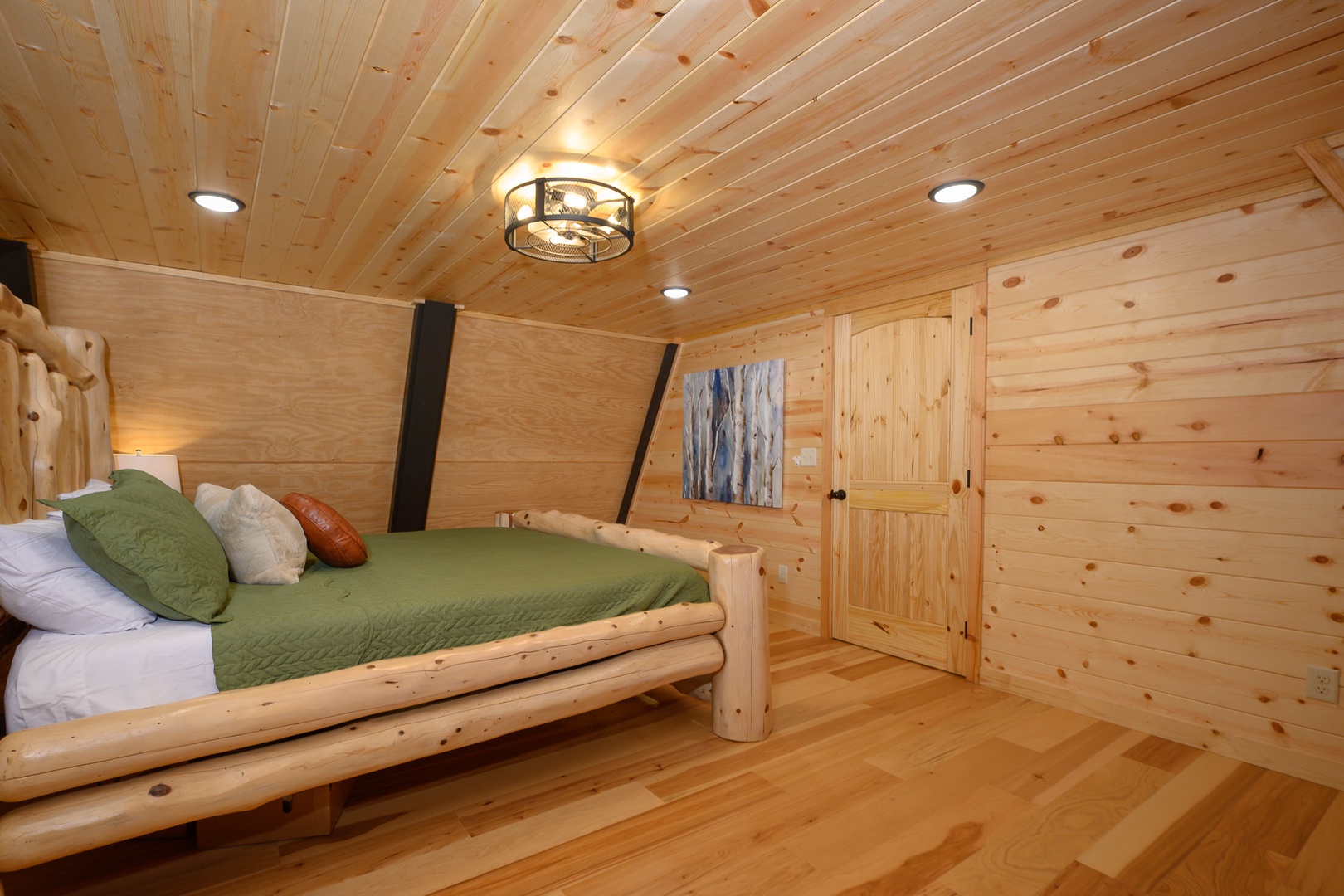 Drift off in your cozy cabin bedroom surrounded by warm wood tones and natural timber details. The handcrafted log bed invites peaceful mountain slumber.