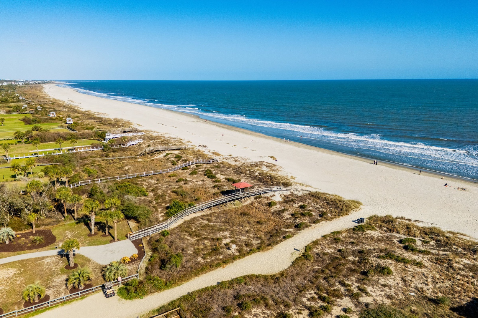 Expansive Atlantic coastline features pristine sandy beaches, natural dune systems, and scenic boardwalks stretching along the shore.