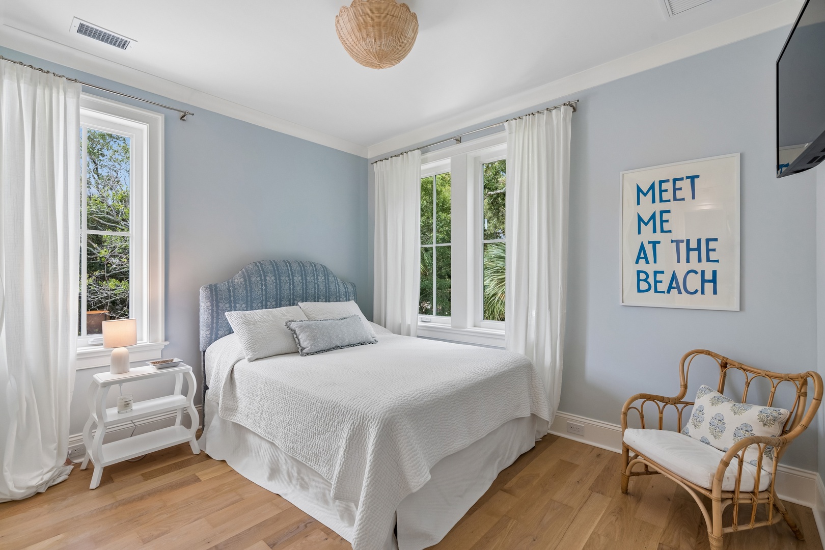 Drift off to sleep in this serene bedroom with soft coastal tones, natural textures, and gentle light filtering through crisp white curtains. Your peaceful retreat awaits.