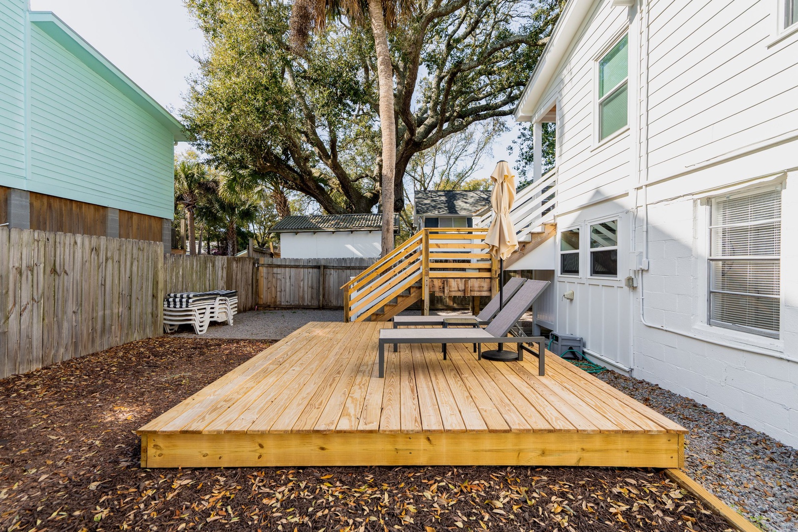 Your private wooden deck offers the perfect spot to unwind with morning coffee or evening relaxation under mature oak trees.
