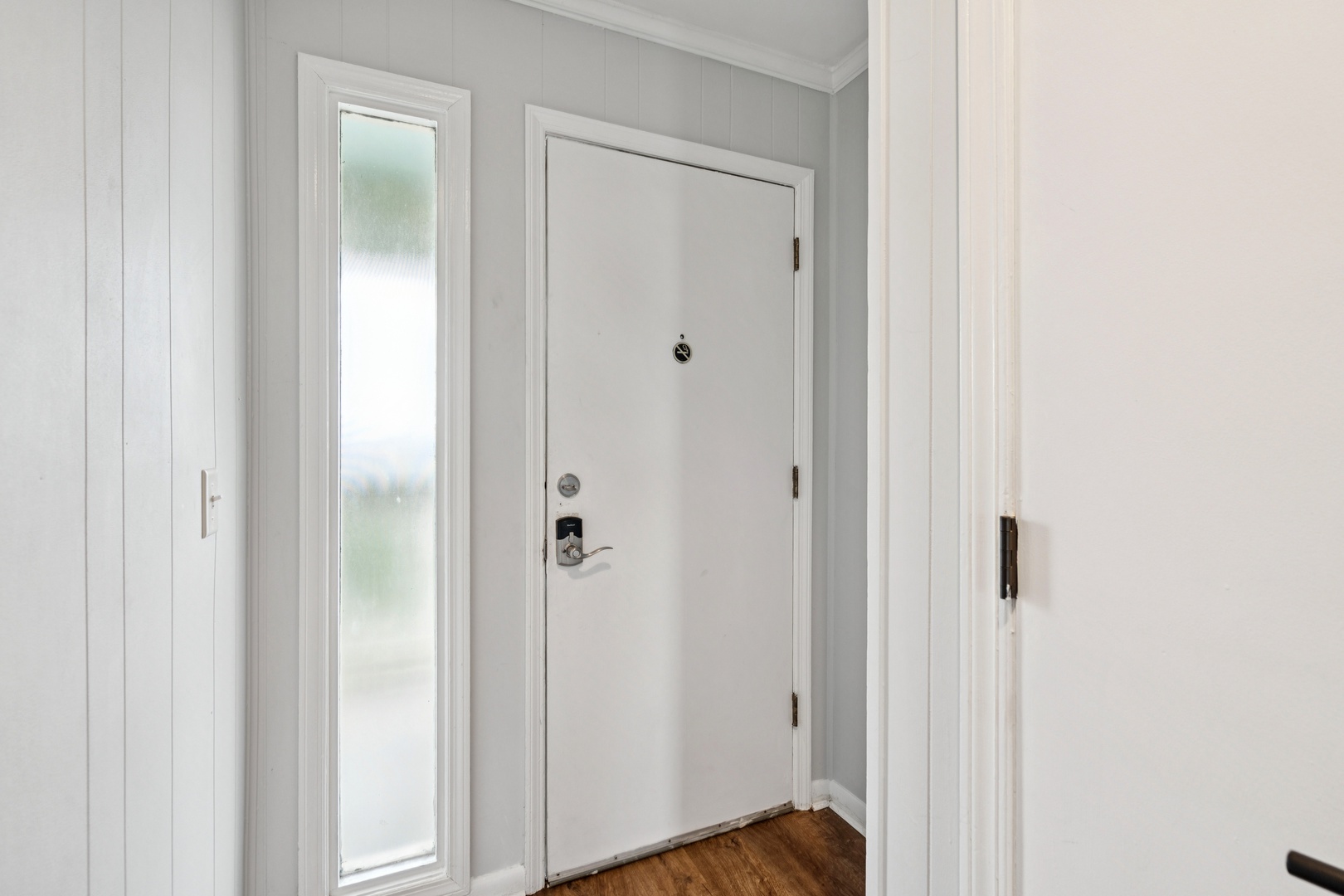 Step through your private entrance into this bright, welcoming space with beautiful hardwood floors and crisp white details.