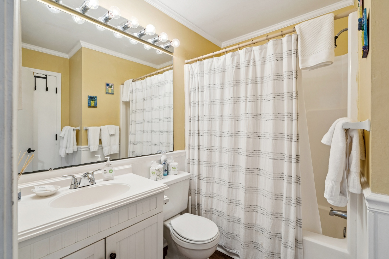 Your bright bathroom features fresh towels, vanity lighting, and a relaxing tub for unwinding after your adventures.
