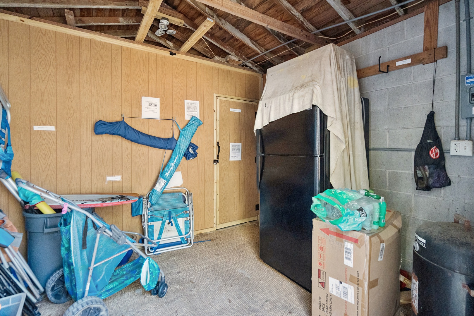 Utility storage space with practical amenities including refrigerator and organized storage solutions for your convenience.