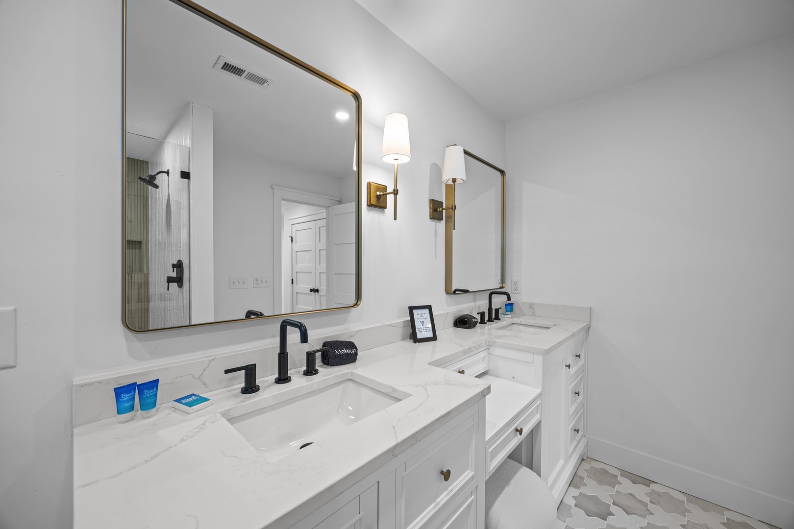 Your elegant bathroom awaits with dual vanities, marble countertops, and modern fixtures for a luxurious morning routine.