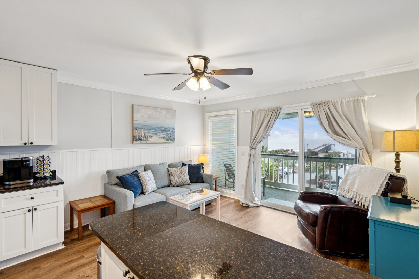 Relax in your bright, airy living space with comfortable seating, modern kitchen amenities, and a private balcony overlooking peaceful surroundings.
