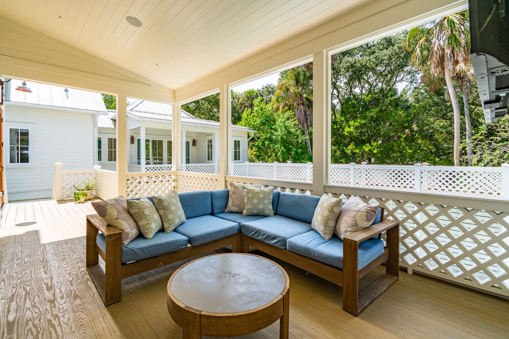 Settle into your private screened porch with plush seating—perfect for morning coffee or unwinding with the breeze and lush tropical views all around.