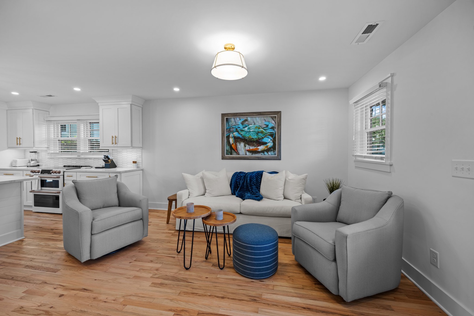 Sink into plush gray seating and enjoy the open-concept design connecting your living space to a fully equipped kitchen.