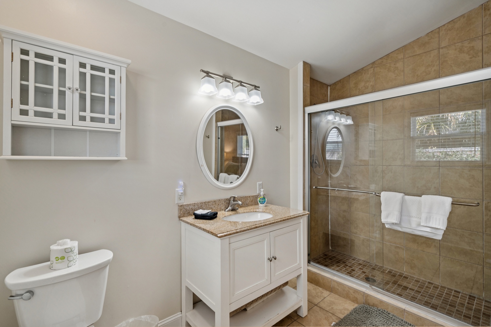 Step into your spa-like bathroom featuring a luxurious walk-in shower with rainfall head and elegant stone tilework throughout.