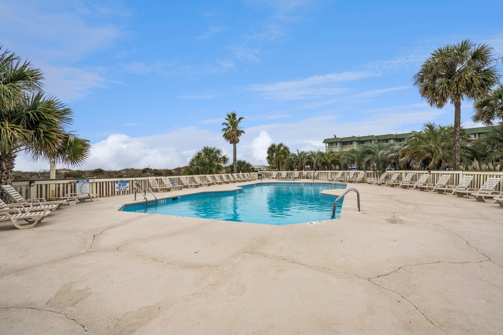 Dive into crystal-clear waters surrounded by swaying palms and comfortable loungers under endless blue skies.