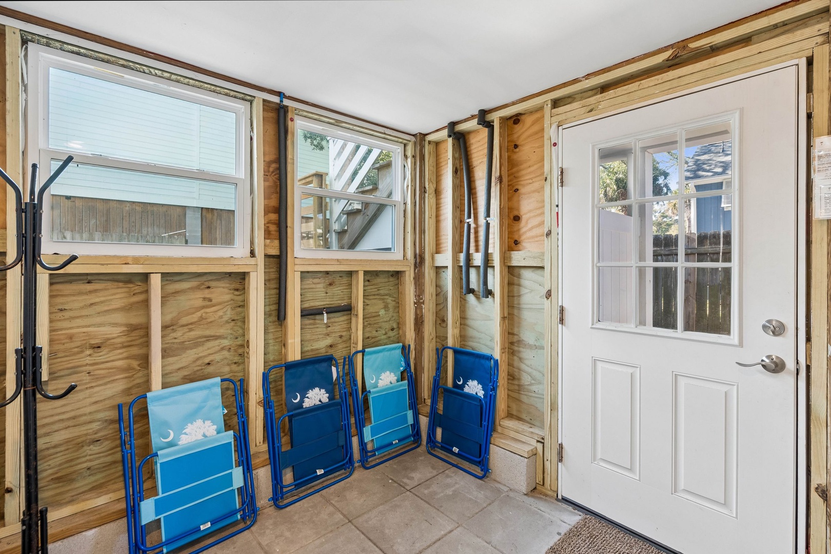 Your enclosed porch offers convenient storage for beach chairs and easy outdoor access through French doors.