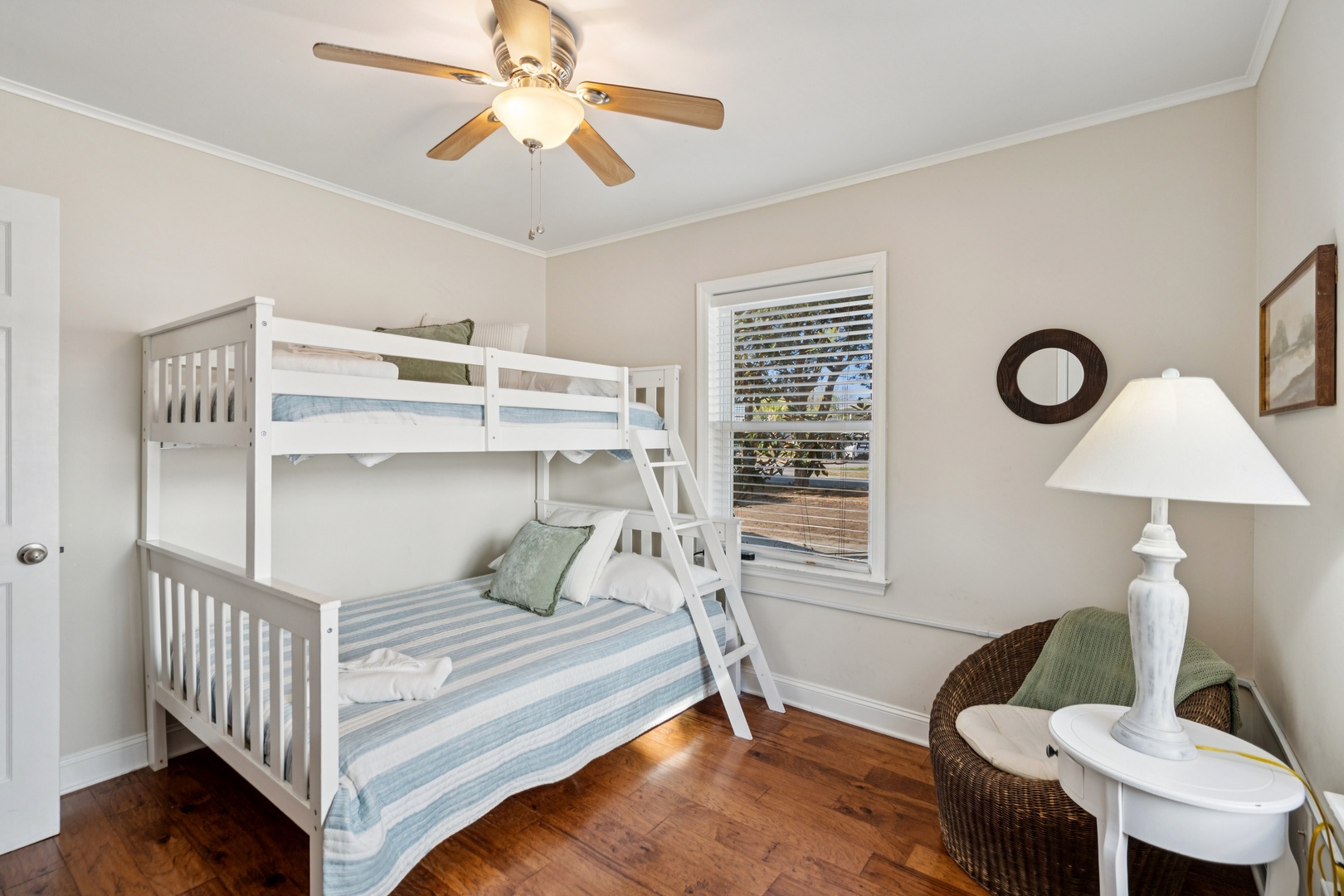 Your kids will love this bright bedroom with white bunk beds and coastal charm—perfect for family adventures and sweet dreams.