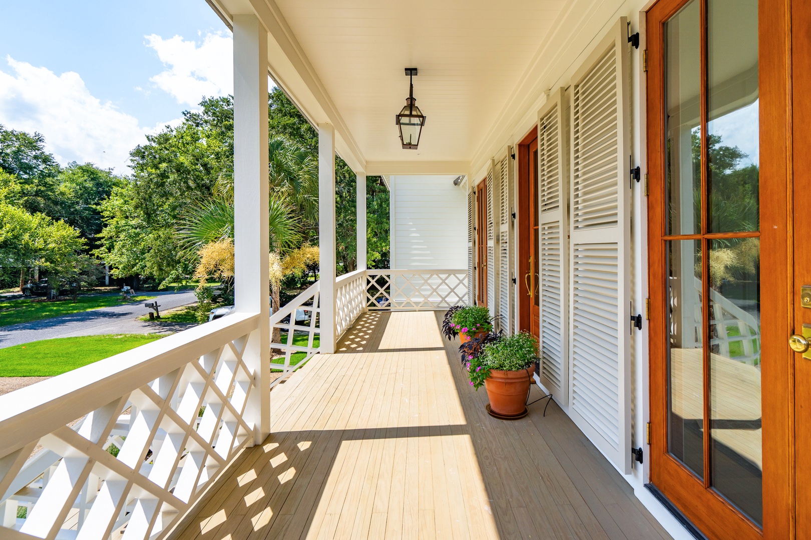This spacious covered porch welcomes you with its classic charm—perfect for your morning coffee as you take in views of the leafy neighborhood streets and beautifully manicured lawns.