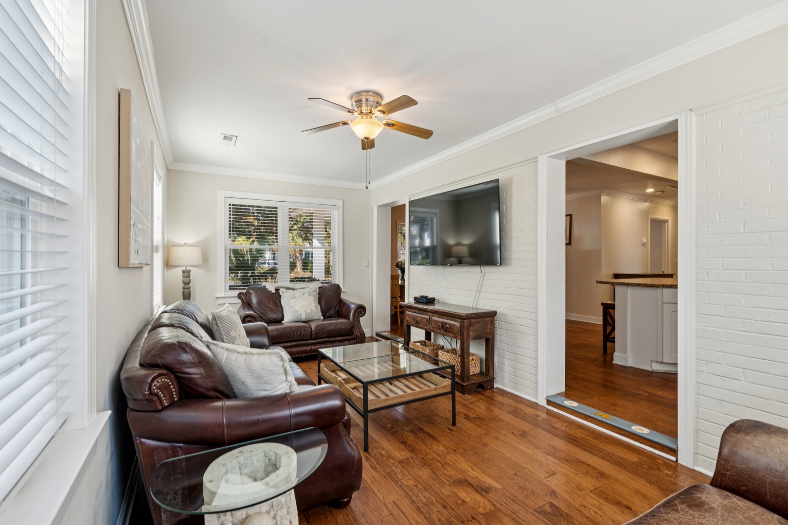 Sink into rich leather seating while enjoying your favorite shows on the wall-mounted TV in this stylish living room.